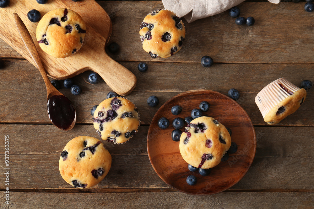 Wooden tray, plate and tasty blueberry muffins on wooden background Wooden tray, plate and tasty blueberry muffins on wooden background