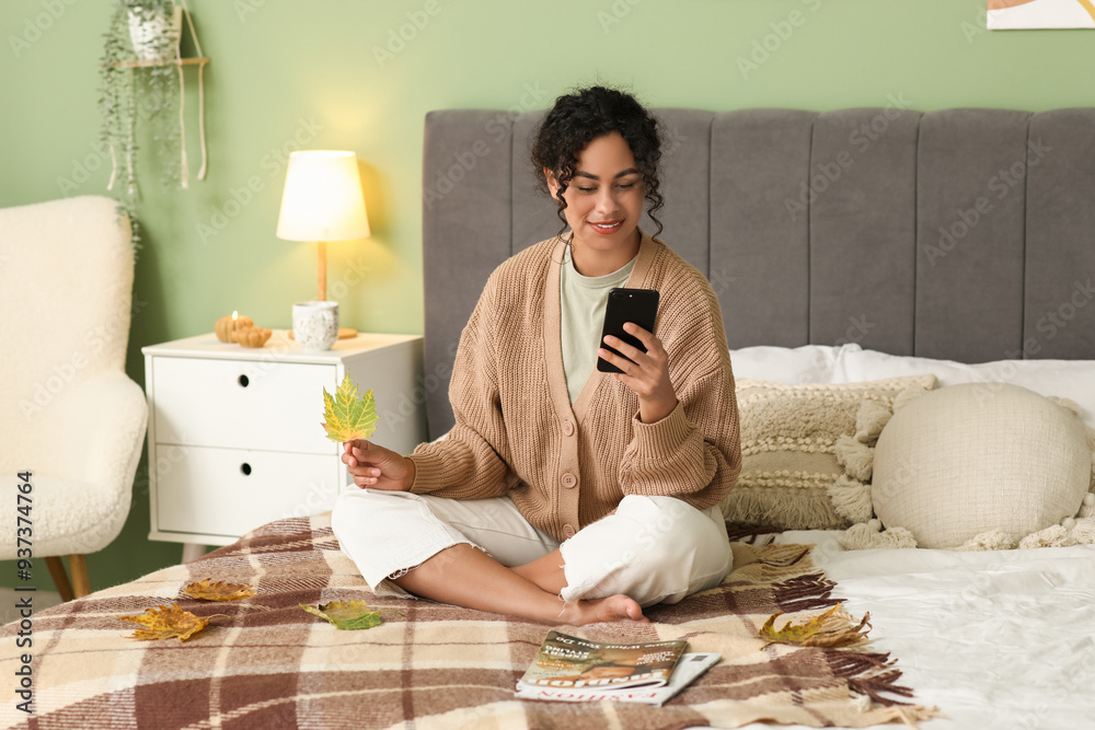 Φωτογραφία Beautiful young happy African-American woman in stylish outfit with autumn leave