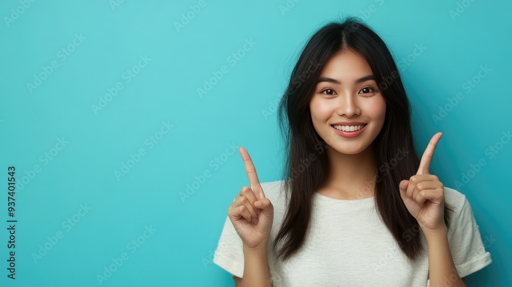 Cheerful Asian Woman Indicating Blank Space with Both Fingers Cheerful Asian Woman Indicating Blank Space with Both Fingers