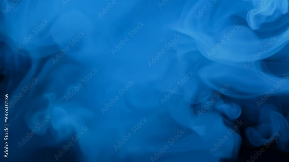 Blue smoke billows in a dark room creating a captivating atmosphere during an artistic performance Blue smoke billows in a dark room creating a captivating atmosphere during an artistic performance