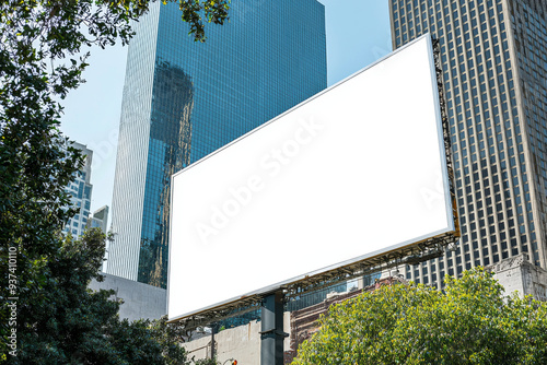 Wallpaper Mural A large white billboard is in front of a tall building. The billboard is empty and has no writing on it. The scene is set in a city with a lot of greenery, including trees and bushes Torontodigital.ca
