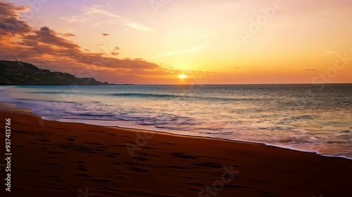 Sunset over the ocean viewed from a sandy beach, capturing vibrant colors and wave reflections at golden hour photo