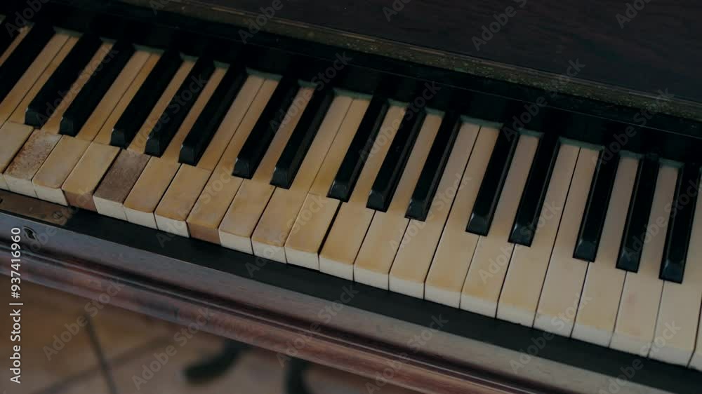 Close-up of an old piano keyboard with worn keys Close-up of an old piano keyboard with worn keys
