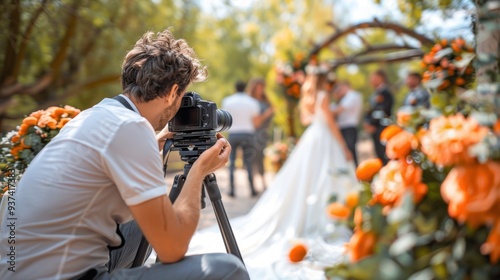 Focused Wedding Shot: A photographer crouches with a camera, professionally capturing the intimate and candid moments of the bride and groom during their wedding.
 photo