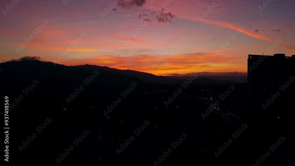Stunning Twilight Over Mountain Silhouette and Cityscape Stunning Twilight Over Mountain Silhouette and Cityscape