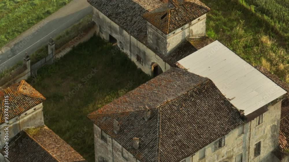An abandoned villa in the italian countryside with overgrown surroundings, aerial view An abandoned villa in the italian countryside with overgrown surroundings, aerial view