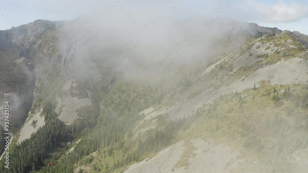 Misty panoramic aerial trucking pan through clouds to sandy slopes with evergreens, Silver Star Mountain Washington Cascades Misty panoramic aerial trucking pan through clouds to sandy slopes with evergreens, Silver Star Mountain Washington Cascades