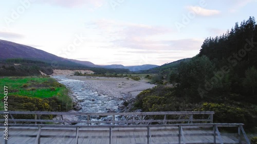 concrete pedestrian bridge over roaring river in scotland photo