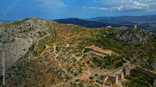 High angle shot of Acrocorinth castle with beautiful landscape at background under cloudy day in Greece. photo