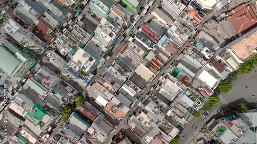 Ho Chi Min City, Vietnam District eight from top down aerial view featuring canal, bridge, rooftops, dense urban housing, streets and alleyways. Ho Chi Min City, Vietnam District eight from top down aerial view featuring canal, bridge, rooftops, dense urban housing, streets and alleyways.