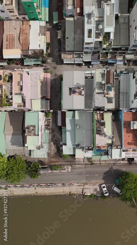 Ho Chi Min City, Vietnam District eight from vertical top down aerial view featuring rooftops, dense urban housing, streets and alleyways. Camera moves from botom to top along alleyway. photo