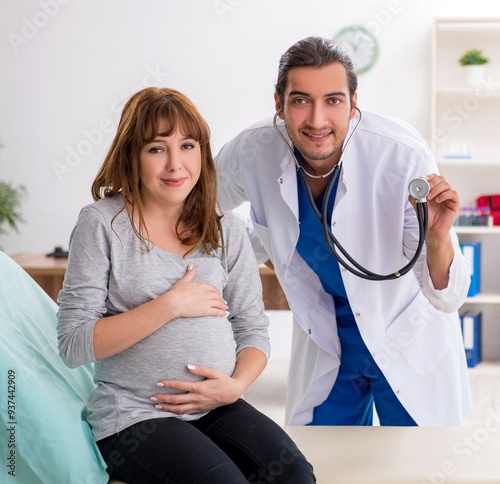 Young woman visting young male doctor gynecologist photo