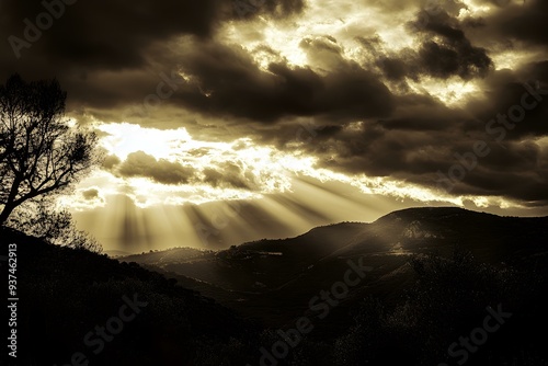 Sun Rays Shining Through Dark Clouds Over Mountains