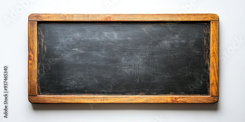 Old chalkboard with visible chalk traces, perfect for educational concepts. Vintage blackboard with wooden frame, offering rustic feel. Blank surface for messages or drawings. Copy space photo