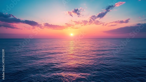 Pink sunset over ocean waves, creating a tranquil and soothing scene of nature's beauty at day's end.