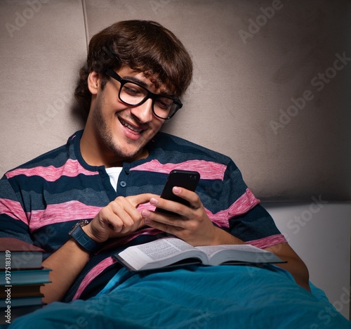 Young student preparing for exams at night at home