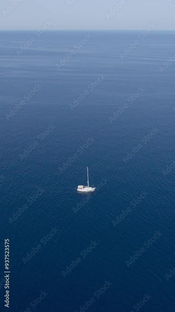 A stunning vertical (reel)view captured by drone along the shores of the Mediterranean Sea. The beautiful Croatian coast during a summer vacation, with boats and yachts slicing through the sea waters. A stunning vertical (reel)view captured by drone along the shores of the Mediterranean Sea. The beautiful Croatian coast during a summer vacation, with boats and yachts slicing through the sea waters.