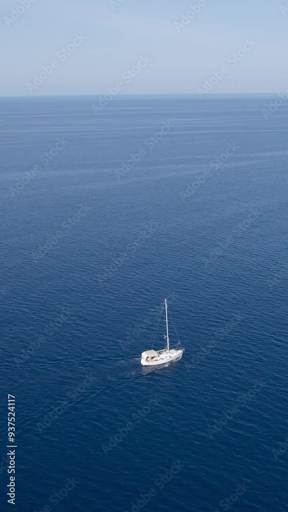 A stunning vertical (reel)view captured by drone along the shores of the Mediterranean Sea. The beautiful Croatian coast during a summer vacation, with boats and yachts slicing through the sea waters. A stunning vertical (reel)view captured by drone along the shores of the Mediterranean Sea. The beautiful Croatian coast during a summer vacation, with boats and yachts slicing through the sea waters.