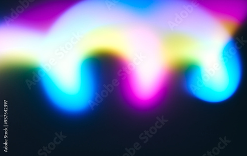 Photo of an abstract background of bright neon waves on a dark background. The dynamic and futuristic effect is ideal for modern design.