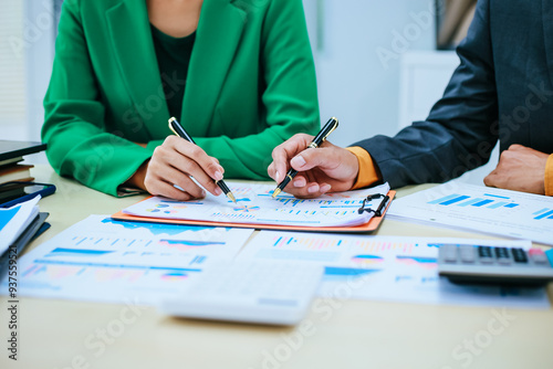 A group of professional business men and women are having a constructive meeting, discussing strategies, exchanging ideas and making decisions in a modern organization. They are wearing formal suits.
 photo