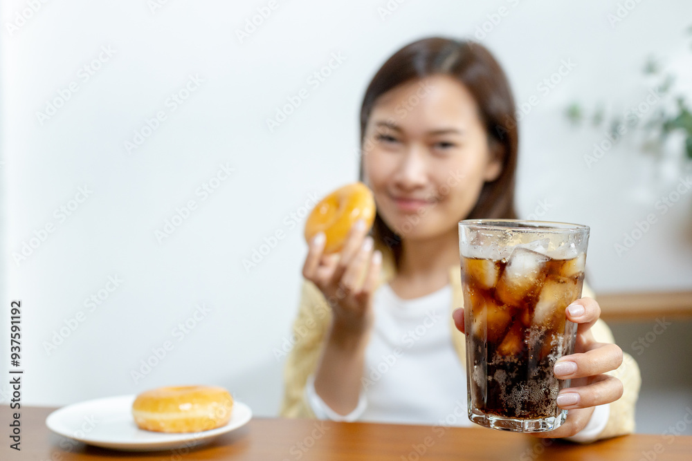 Close up sweet drink, Dieting healthy concept, Stop sugar lose weight, healthy diet, Choosing good food for health benefits. snack junk food unhealthy. Girl hand holding glass of black water. Close up sweet drink, Dieting healthy concept, Stop sugar lose weight, healthy diet, Choosing good food for health benefits. snack junk food unhealthy. Girl hand holding glass of black water.