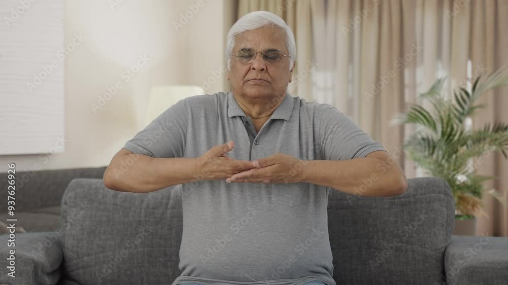 Relaxed Indian old man doing breathe in breathe out exercise Relaxed Indian old man doing breathe in breathe out exercise
