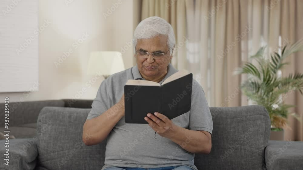 Indian old man drinking tea and reading book Indian old man drinking tea and reading book