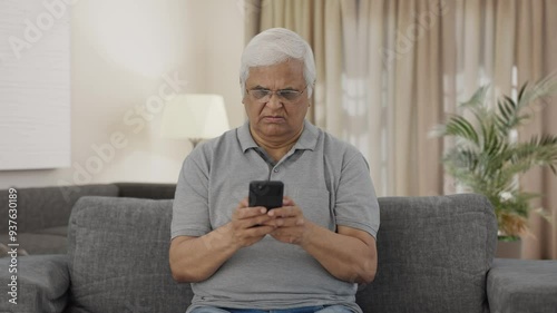 Angry Indian old man chatting on phone