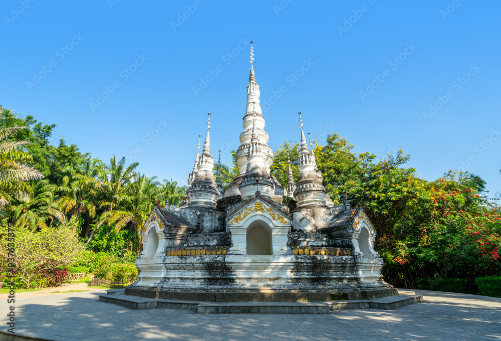 White pagoda in Buddhist temple in Xishuangbanna, Sipsongpanna, or Sibsongbanna in the south of Yunnan province, People's Republic of China. White pagoda in Buddhist temple in Xishuangbanna, Sipsongpanna, or Sibsongbanna in the south of Yunnan province, People's Republic of China.