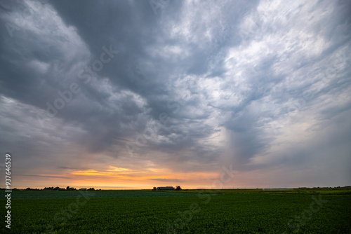Fototapeta Naklejka Na Ścianę i Meble -  Storm clouds gather over the wide open plains at sunset