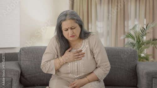 Sick Indian old woman suffering from cold and cough