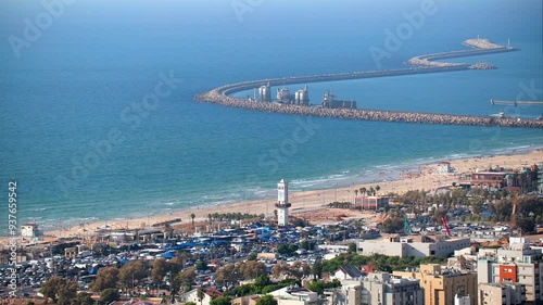 City skyline with a large body of water in the background. Ashdod in Israel. View on the beach and port. The buildings are tall and the city appears to be bustling with activity. High quality 4k