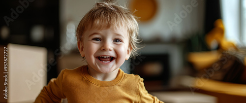 Happy little boy running in the living room  photo