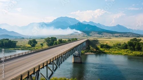 Bridge Over River Leading to Mountain Range