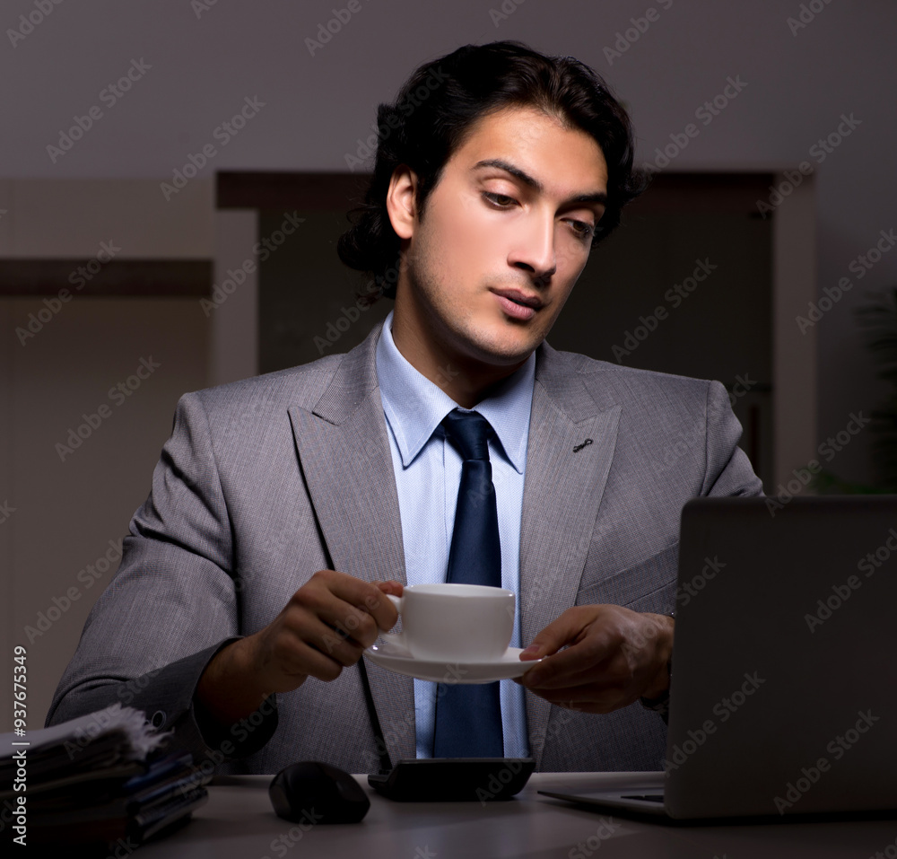 Young handsome employee and too much work in the office Young handsome employee and too much work in the office