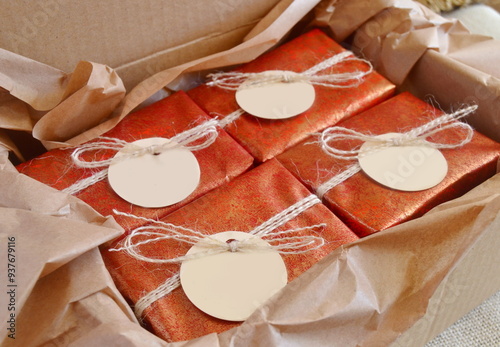 Christmas gifts red color boxes jute ribbon mockup tags, winter wedding favors handmade souvenirs, homemade crafts party presents, natural soap bars, brown craft paper background