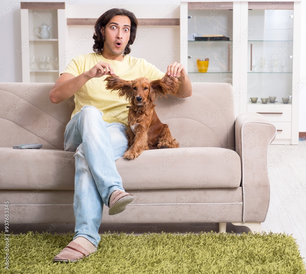 Young man with cocker spaniel dog