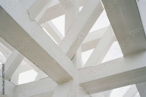 An abstract shot of white geometric structures intersecting and overlapping  forming a visually striking pattern with minimalistic appeal.