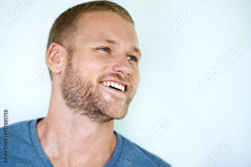 Laugh, thinking and face of man in studio with casual fashion, confidence and creative inspiration. Happy, ideas and young professional with pride, cool style and mockup space on white background