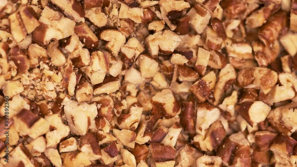 Close up of caramel pouring on crushed pecans, confectioner and pastry Close up of caramel pouring on crushed pecans, confectioner and pastry