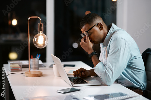 Business man, laptop and night in office with tired and stress from project with digital planning. Technology, burnout and African professional with anxiety and research problem for website strategy