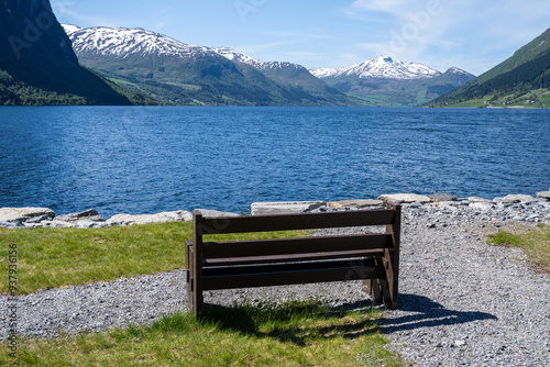 Bench by the  Joelster lake in West Norway at a sunny day photo