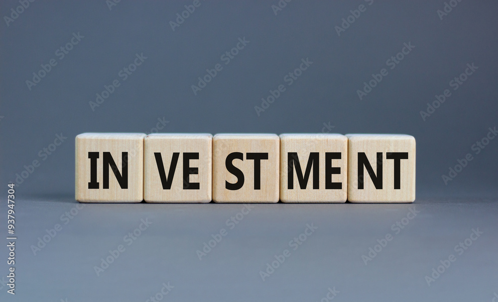 Investment symbol. Concept word Investment on beautiful wooden blocks. Beautiful grey background. Business investment concept. Copy space. Investment symbol. Concept word Investment on beautiful wooden blocks. Beautiful grey background. Business investment concept. Copy space.