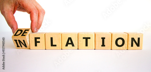 Deflation or inflation symbol. Concept word Deflation Inflation on beautiful wooden cubes. Beautiful white table white background. Businessman hand. Business deflation or inflation concept. Copy space photo