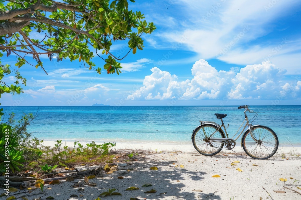 Fototapeta premium A bicycle parked on a sandy beach next to the ocean, suitable for use in travel or outdoor-themed projects