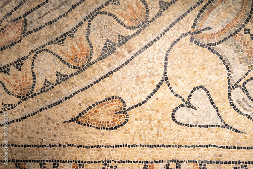 Detail of a mosaic showing a single plant branch with heart-shaped leaves  sticking out from an amphor photo