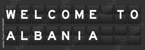 Black color analog flip board with word welcome to albania on gray background