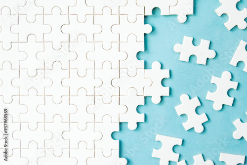 messy white jigsaw puzzles on blue background
