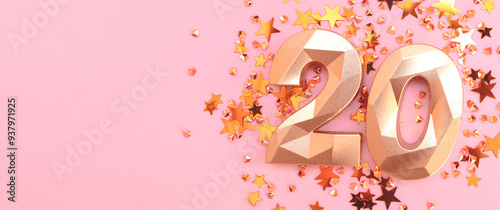 Banner with number twenty and stars confetti on a pink background.