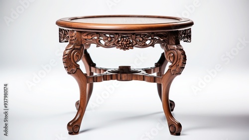 An elegant antique table with intricate carvings and a polished wood surface, isolated on a pristine white canvas. photo